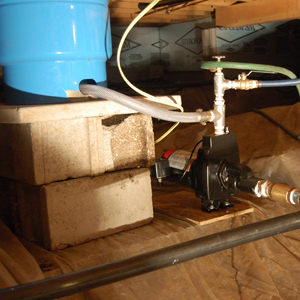 The tank and pump on their cement base